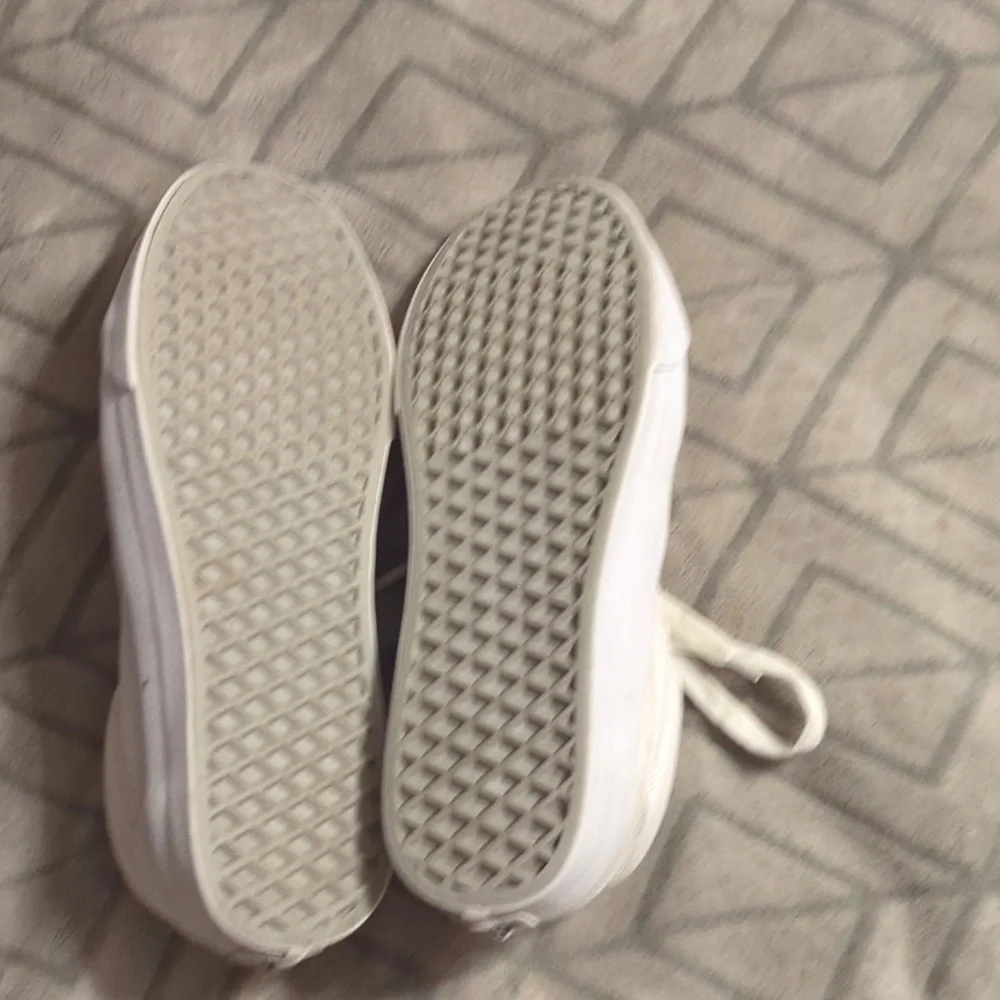 Vans Old Skool shoes in the True White or Monochrome‎ White colorway.